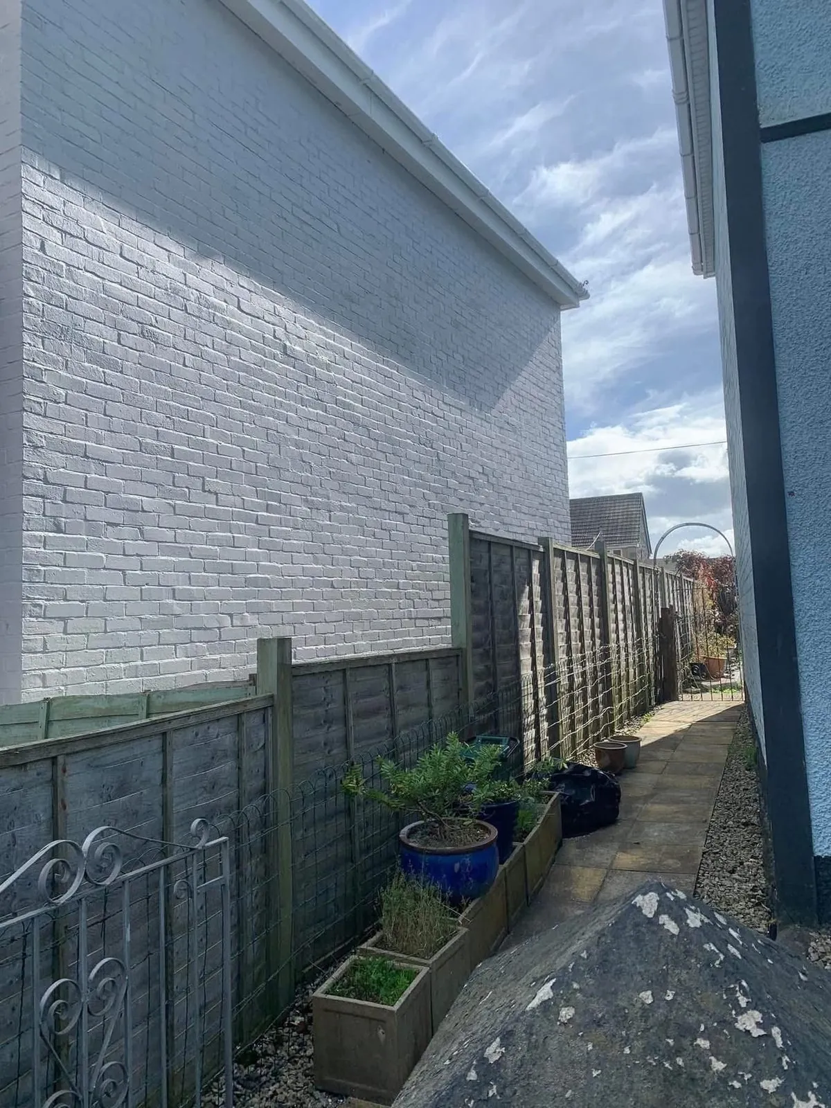 Freshly painted brick wall after preparation and masonry paint in Treverbyn